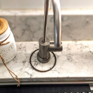 A placing Jane Tensor Ring around an R.O. faucet