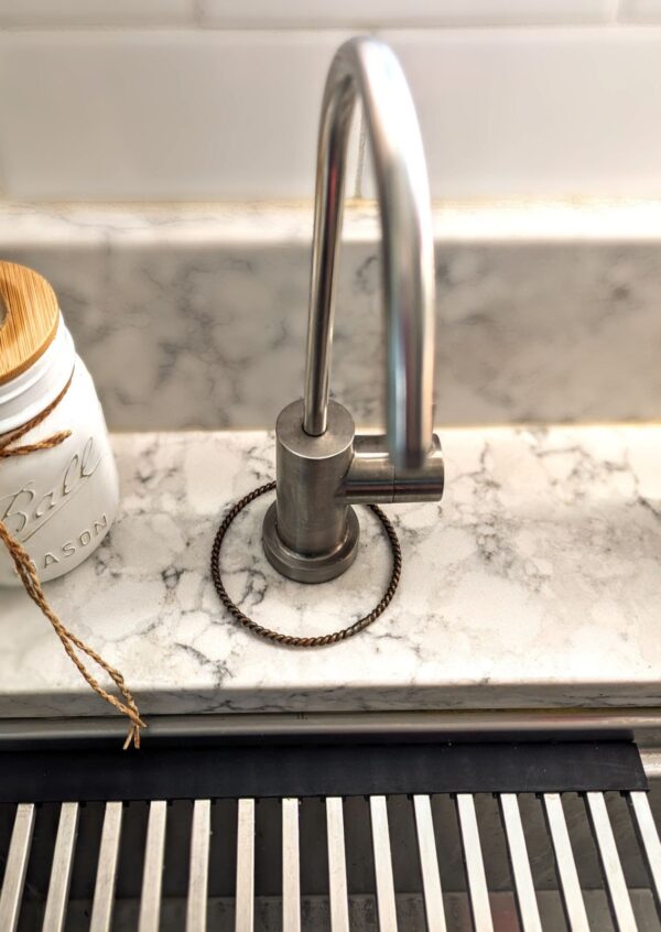 A placing Jane Tensor Ring around an R.O. faucet