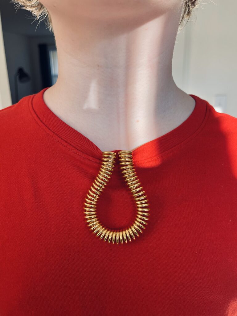 Feedback Loop hooked on neck of child's red t-shit
